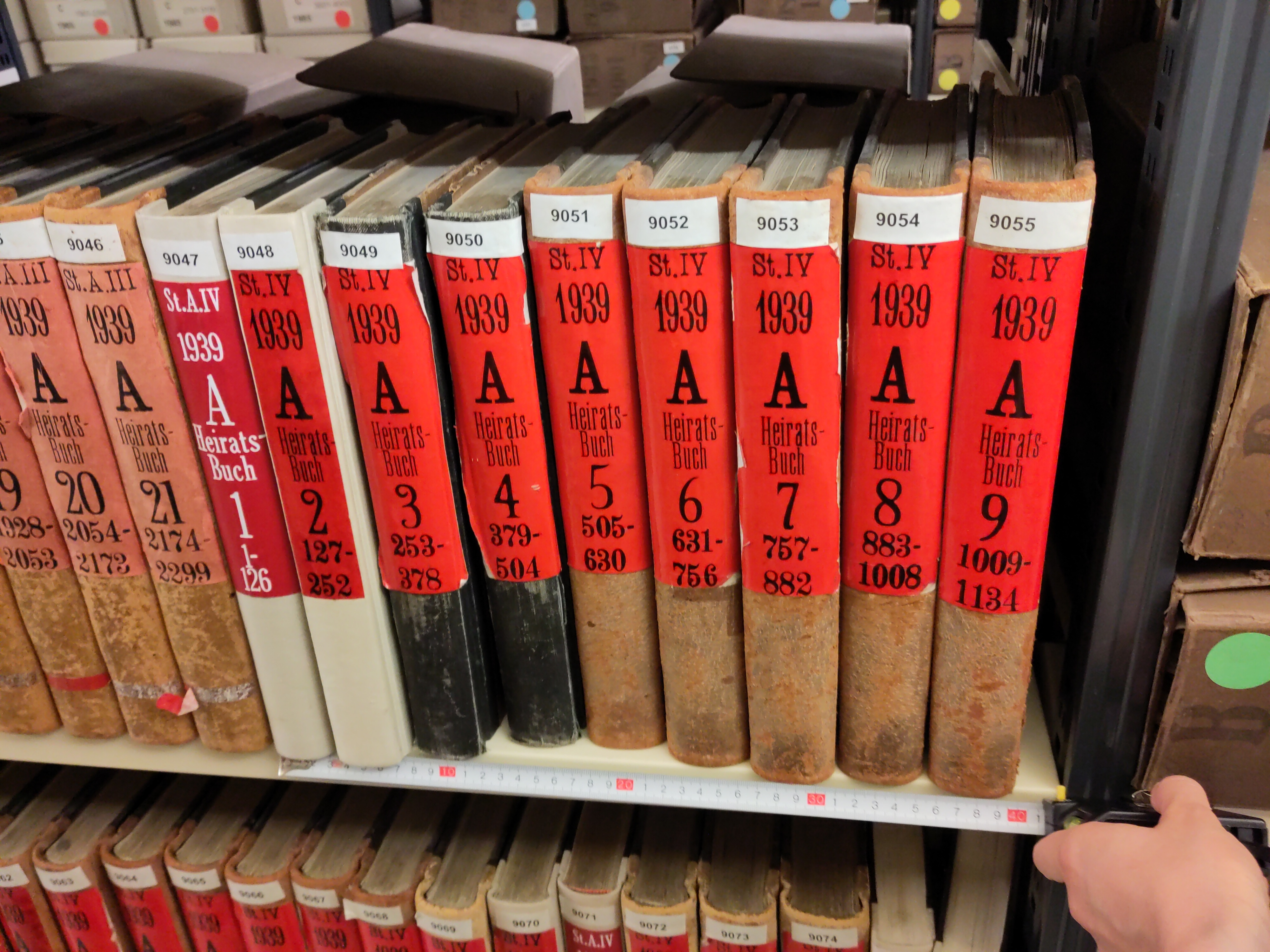 Zu sehen ist ein Regal mit Standesamtsbücher. Neun dieser Bücher bilden 40 Zentimeter Archivgut ab.